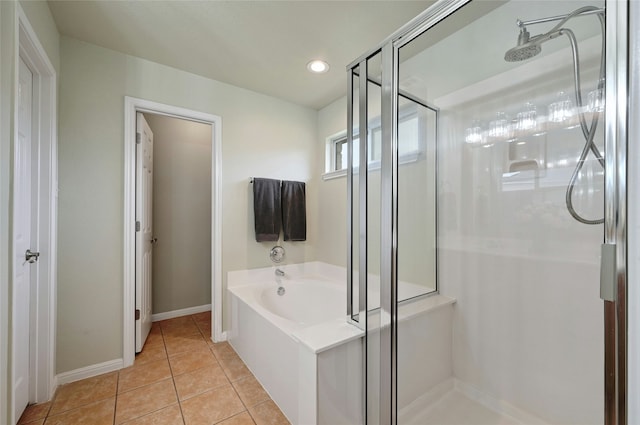 full bath with a stall shower, baseboards, a bath, and tile patterned floors