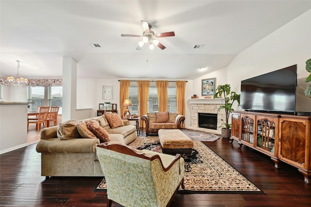 living area with lofted ceiling, visible vents, dark wood-style flooring, and ceiling fan with notable chandelier