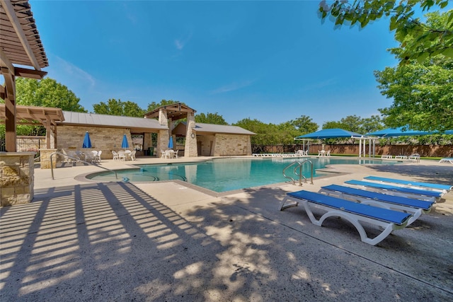 community pool featuring a patio and fence