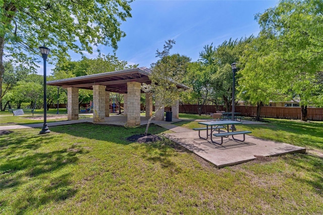 view of community with a patio, a yard, a gazebo, and fence