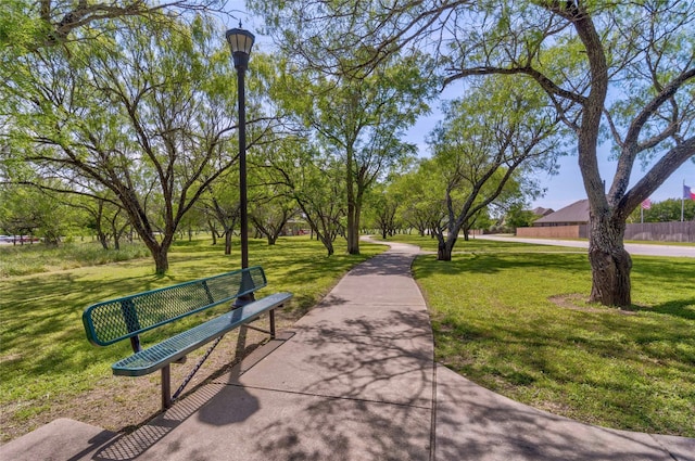 view of home's community with a yard