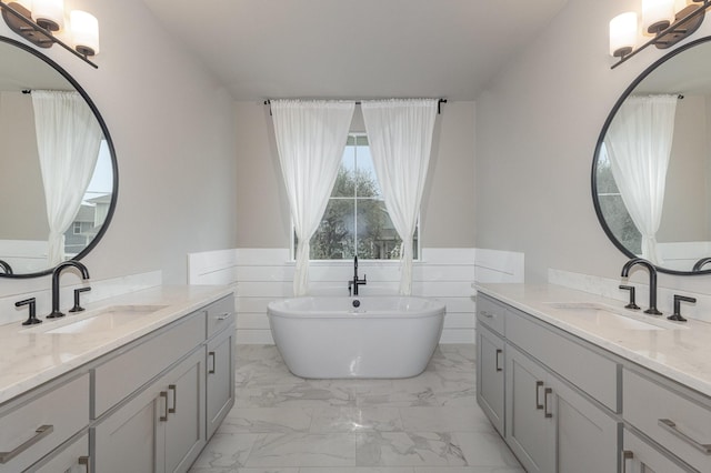 bathroom featuring vanity and a tub to relax in