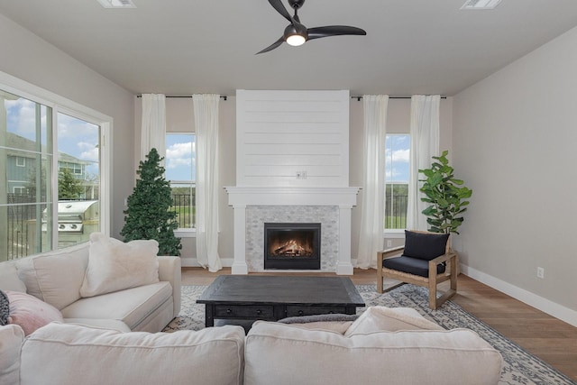 living room featuring ceiling fan and light hardwood / wood-style floors