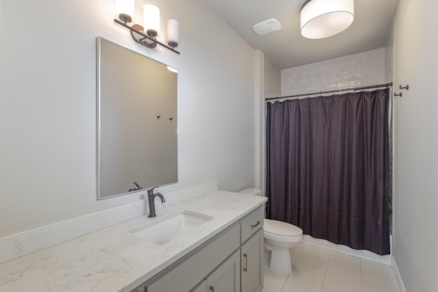 bathroom featuring tile patterned flooring, vanity, walk in shower, and toilet