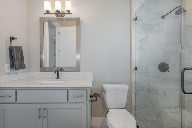 bathroom featuring an enclosed shower, vanity, and toilet