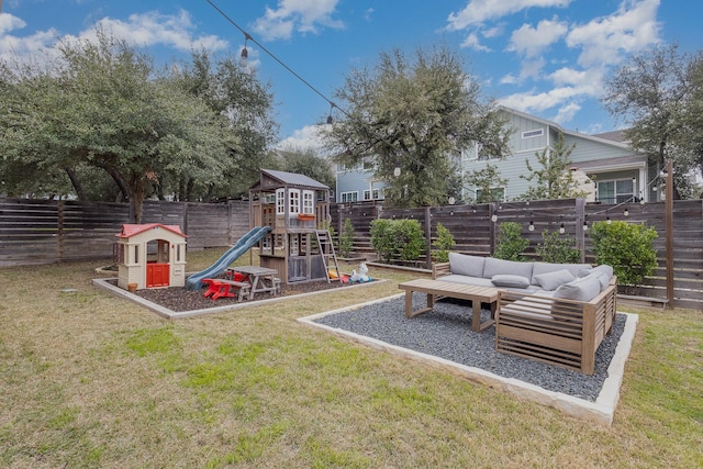 view of play area with an outdoor living space and a yard