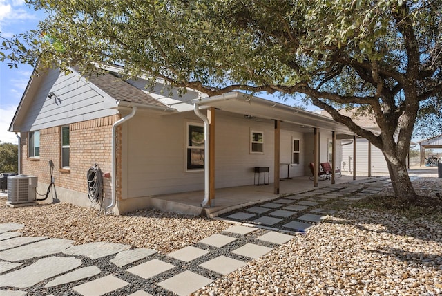 rear view of property featuring a patio area and central air condition unit