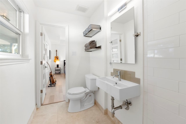 bathroom with sink, tile patterned floors, and toilet