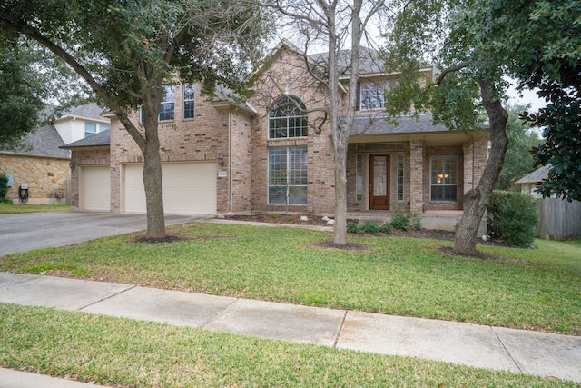 view of front of house featuring a garage and a front lawn