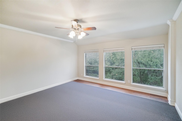 carpeted spare room with ceiling fan and ornamental molding