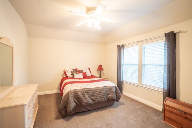 carpeted bedroom with vaulted ceiling and ceiling fan