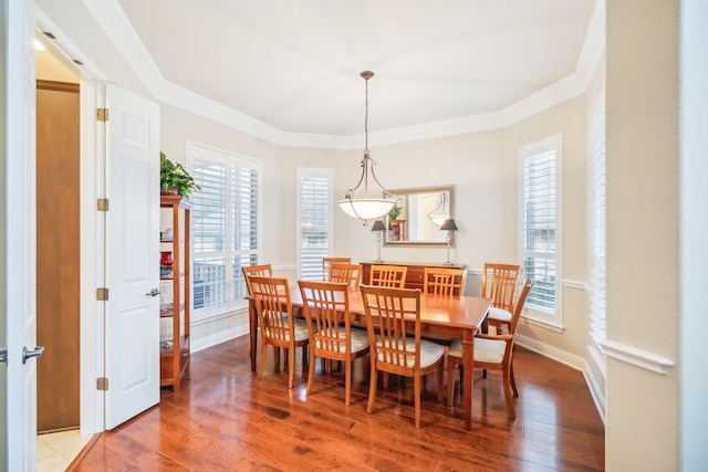 dining room with hardwood / wood-style flooring, plenty of natural light, and crown molding