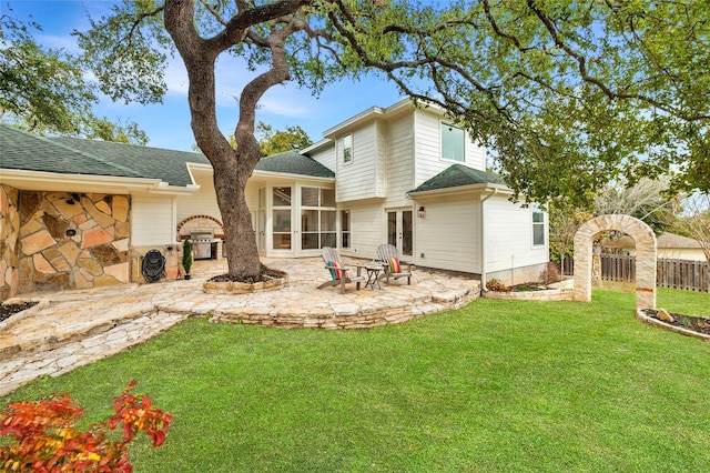 back of house with a patio, a sunroom, and a yard