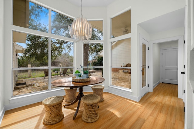 sunroom with an inviting chandelier