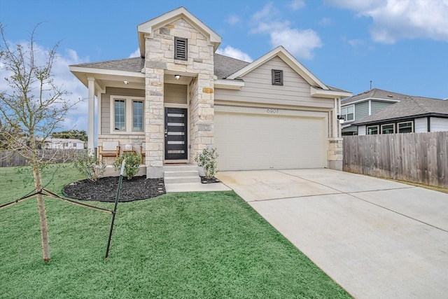 view of front of house featuring a garage and a front lawn