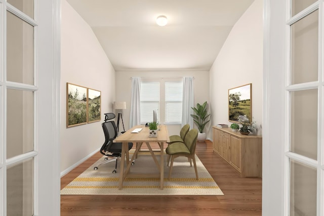 dining space featuring lofted ceiling and light hardwood / wood-style flooring