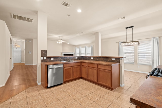 kitchen featuring pendant lighting, light tile patterned floors, sink, ceiling fan, and stainless steel dishwasher