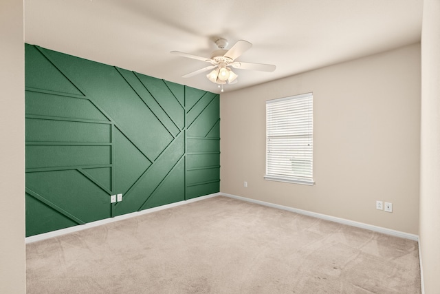 empty room with ceiling fan and carpet floors