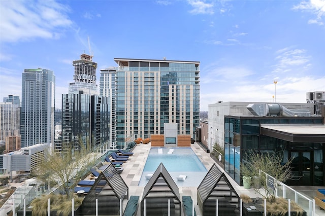 view of pool featuring a grill and a patio area