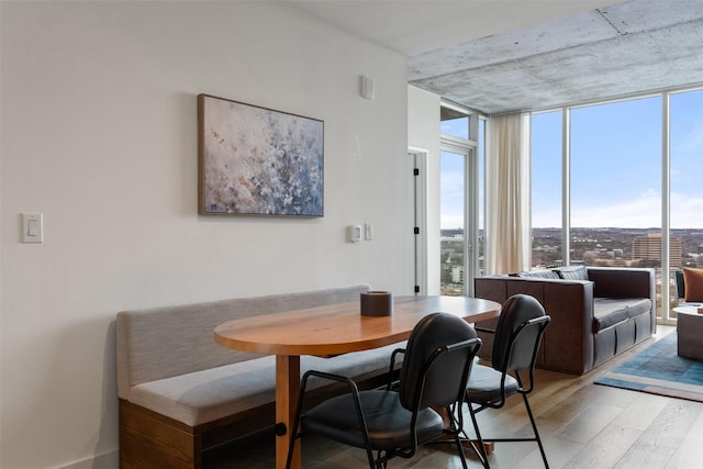 dining space featuring hardwood / wood-style flooring and floor to ceiling windows