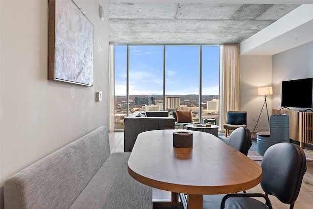 dining area featuring plenty of natural light and a wall of windows