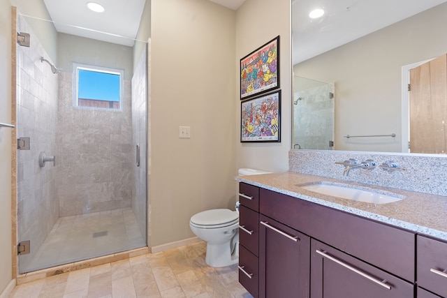 bathroom featuring vanity, a shower with door, and toilet