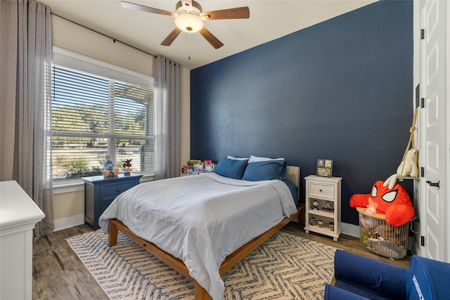 bedroom with hardwood / wood-style floors and ceiling fan