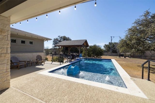 view of pool with a gazebo, a patio area, and pool water feature