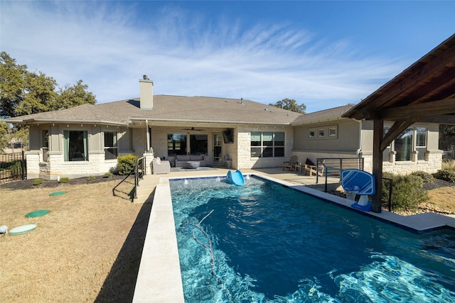 view of pool with ceiling fan, an outdoor hangout area, and a patio area