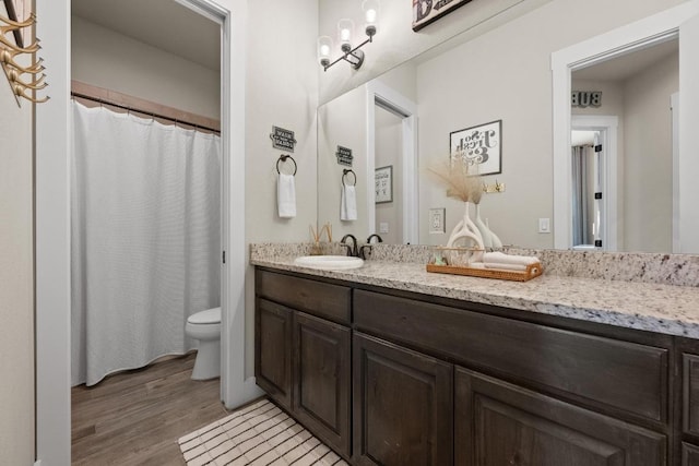 105 Aldea St, Georgetown, TX 78633 - full bathroom with double vanity, wood finished floors, and a shower with shower curtain