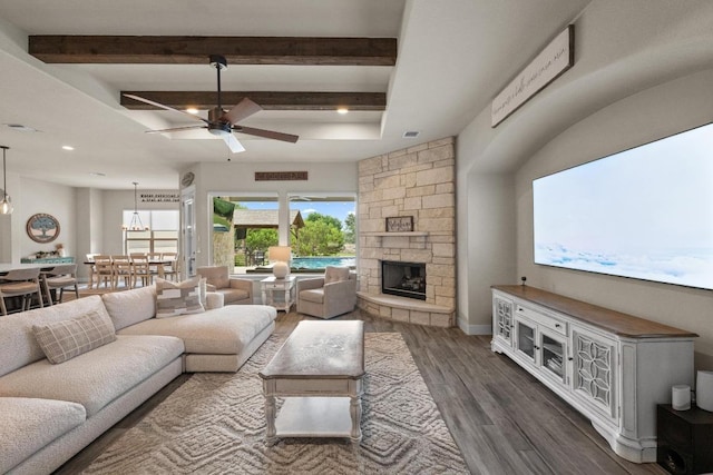 105 Aldea St, Georgetown, TX 78633 - living room with ceiling fan, wood finished floors, a stone fireplace, beamed ceiling, and recessed lighting