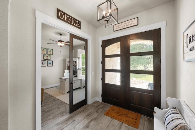 105 Aldea St, Georgetown, TX 78633 - foyer entrance with french doors, healthy amount of natural light, light wood-style flooring, and a chandelier