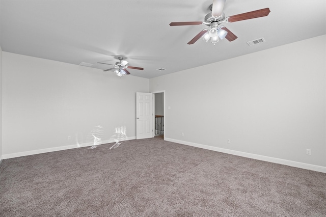 empty room featuring a ceiling fan, baseboards, visible vents, and carpet flooring