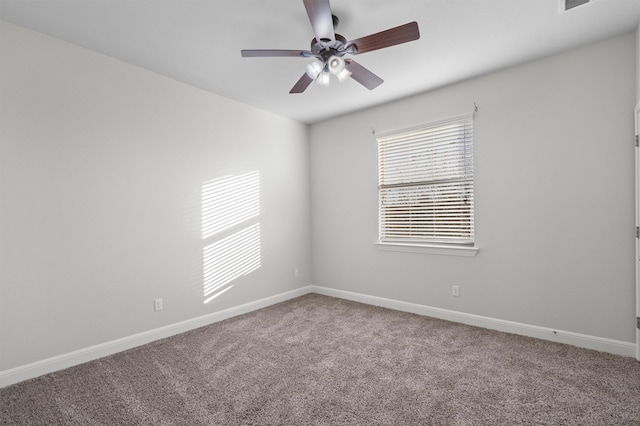 carpeted empty room featuring visible vents, baseboards, and a ceiling fan