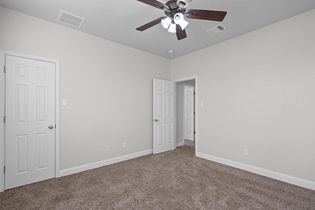 unfurnished bedroom featuring carpet floors, visible vents, and baseboards