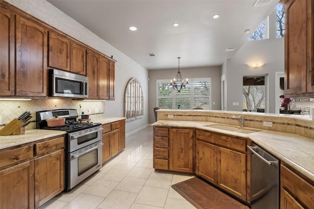 2007 Big Horn Dr, Austin, TX 78734 - kitchen with stainless steel appliances, decorative backsplash, a sink, recessed lighting, and a chandelier