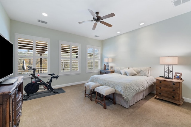 carpeted bedroom with multiple windows and ceiling fan