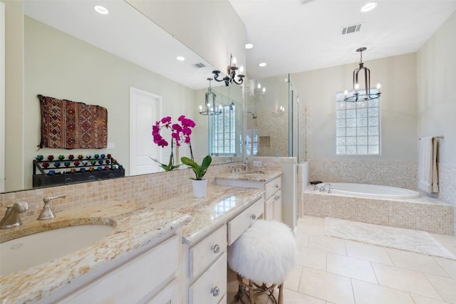 2007 Big Horn Dr, Austin, TX 78734 - bathroom with a chandelier, a bath, double vanity, recessed lighting, and tile patterned flooring