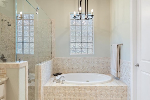 2007 Big Horn Dr, Austin, TX 78734 - full bath with a shower stall, a bath, and a chandelier