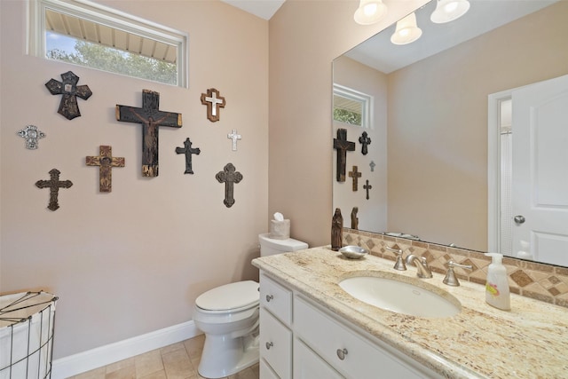 bathroom featuring tasteful backsplash, vanity, tile patterned flooring, and toilet