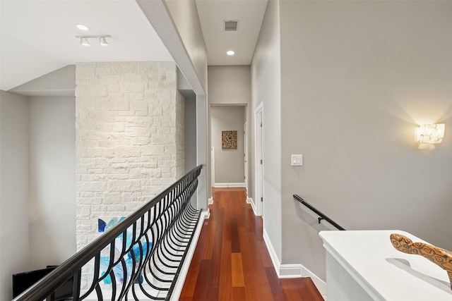 hall with lofted ceiling and dark hardwood / wood-style floors