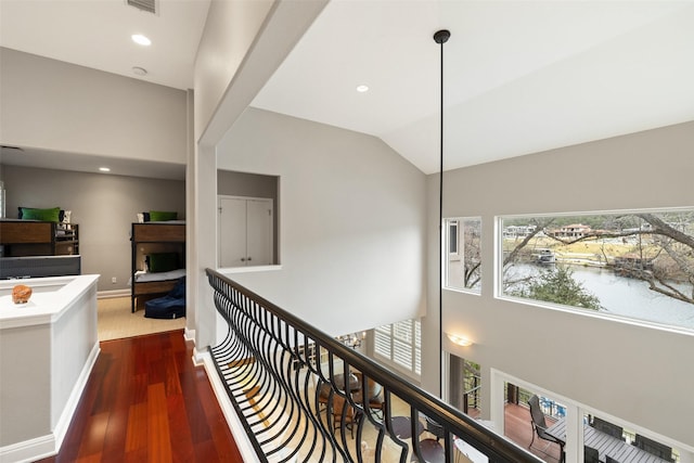 corridor featuring dark hardwood / wood-style floors and vaulted ceiling