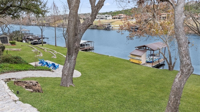 exterior space with a water view and a lawn