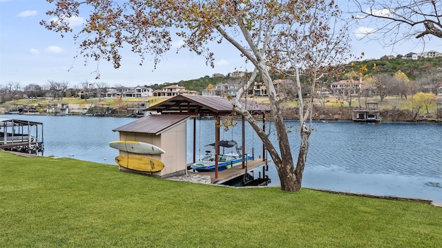 view of dock with a water view and a yard