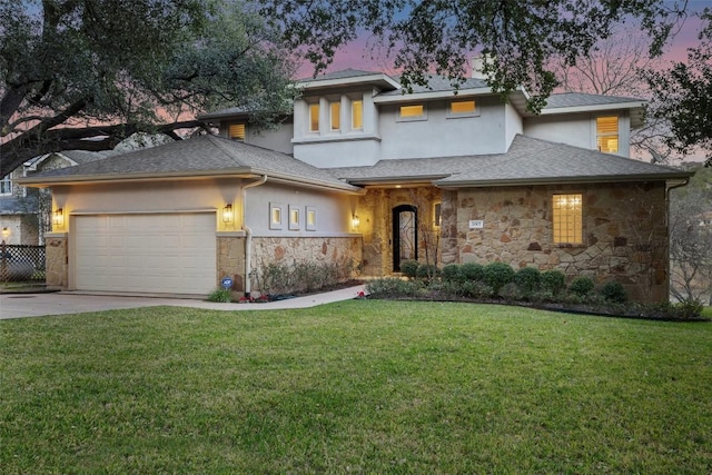 prairie-style house with a garage and a lawn