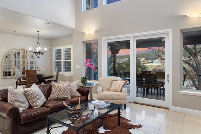 living room with light tile patterned floors and a notable chandelier