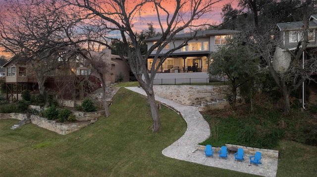 yard at dusk with a patio area