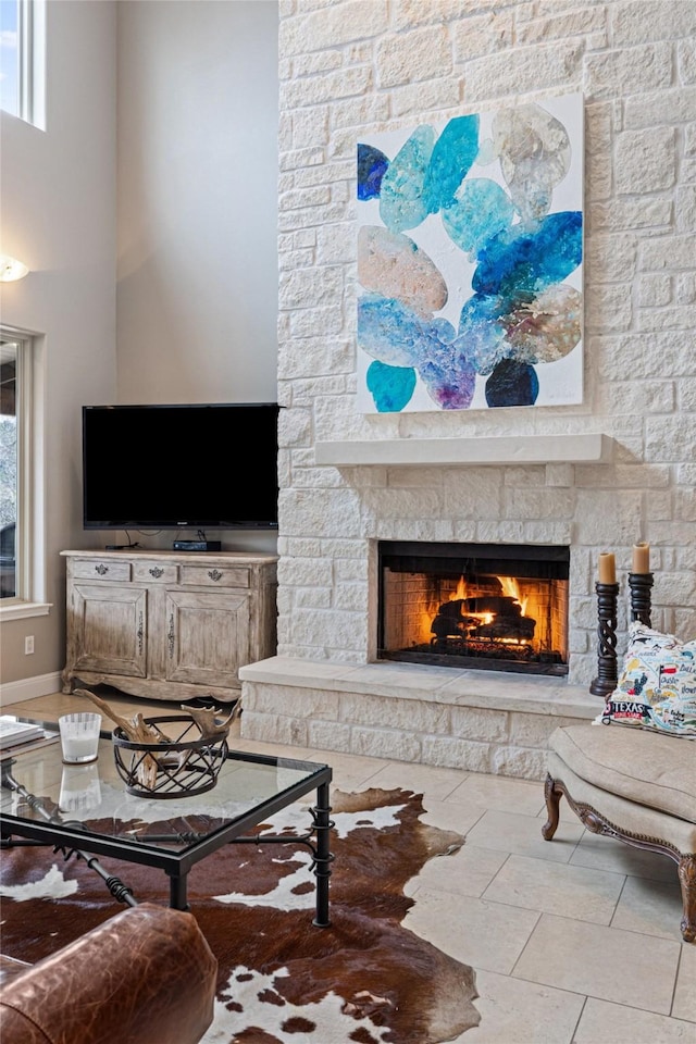 living room with a stone fireplace