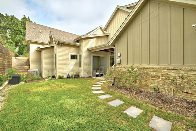 back of property featuring a lawn