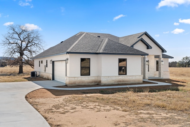 view of home's exterior featuring a garage and central AC